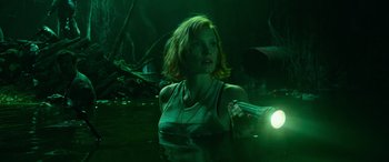 Movie still from “It Chapter Two” (2019), directed by Andy Muschietti – A woman holding a flashlight while standing in a swamp; Medium shot, Low angle