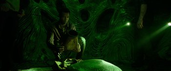 Movie still from “It Chapter Two” (2019), directed by Andy Muschietti – A man is holding a piece of food in his hands; Medium shot, Overhead angle