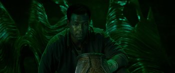 Movie still from “It Chapter Two” (2019), directed by Andy Muschietti – A man in a green shirt is sitting in front of a lamp; Close Up shot, High angle