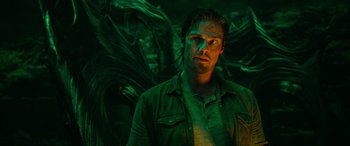 Movie still from “It Chapter Two” (2019), directed by Andy Muschietti – A man standing in front of a wall with green lighting; Medium shot, Low angle