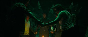 Movie still from “It Chapter Two” (2019), directed by Andy Muschietti – A group of people holding hands in a circle; Medium shot, High angle