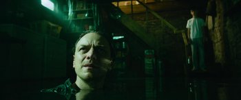 Movie still from “It Chapter Two” (2019), directed by Andy Muschietti – A man in a dark room looking into the distance; Close Up shot, Low angle