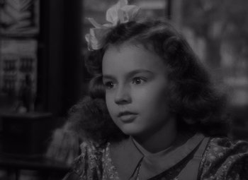 Movie still from “It's a Wonderful Life” (1946), directed by Frank Capra – A black and white photo of a young girl; Close Up shot, High angle
