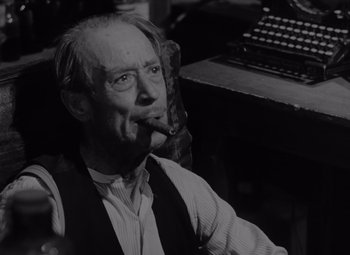 Movie still from “It's a Wonderful Life” (1946), directed by Frank Capra – An old man sitting in front of an old typewriter; Close Up shot, Low angle