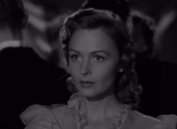 Movie still from “It's a Wonderful Life” (1946), directed by Frank Capra – A black - and - white photo of a woman in a white dress; Close Up shot, High angle