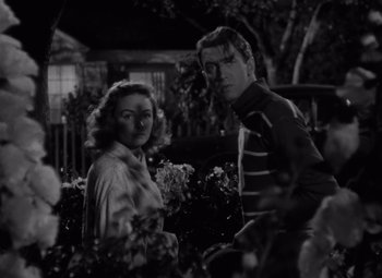 Movie still from “It's a Wonderful Life” (1946), directed by Frank Capra – A black and white photo of a man and a woman; Medium shot, Low angle