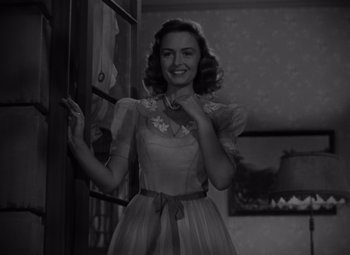 Movie still from “It's a Wonderful Life” (1946), directed by Frank Capra – A black and white photo of a woman in a dress; Medium shot, Low angle