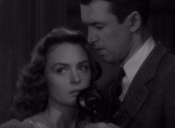 Movie still from “It's a Wonderful Life” (1946), directed by Frank Capra – A man and a woman are looking at each other; Close Up shot, Low angle