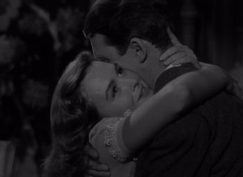 Movie still from “It's a Wonderful Life” (1946), directed by Frank Capra – A man and a woman embracing each other in a black and white photo; Close Up shot, High angle