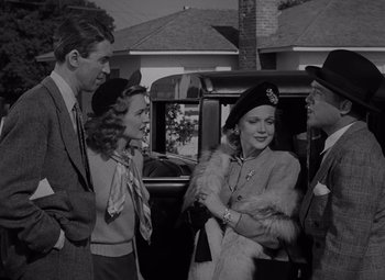 Movie still from “It's a Wonderful Life” (1946), directed by Frank Capra – A black and white photo of a group of people standing next to each other; Medium shot, Low angle