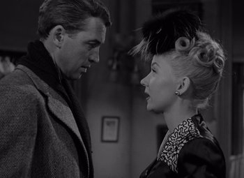 Movie still from “It's a Wonderful Life” (1946), directed by Frank Capra – A man and a woman standing next to each other in a room; Close Up shot, Over the shoulder angle