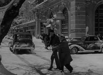 Movie still from “It's a Wonderful Life” (1946), directed by Frank Capra – A black and white photo of people walking down a street; Extreme Wide shot, High angle
