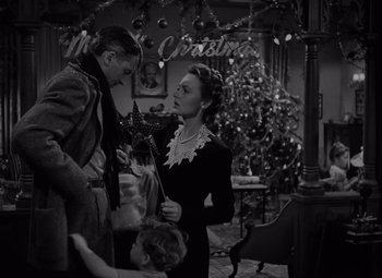 Movie still from “It's a Wonderful Life” (1946), directed by Frank Capra – A man and a woman standing in front of a christmas tree; Medium shot, Low angle