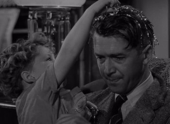 Movie still from “It's a Wonderful Life” (1946), directed by Frank Capra – An old photo of a man and a little girl; Close Up shot, Over the shoulder angle