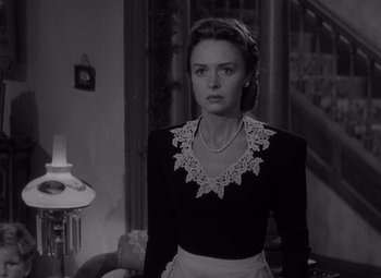 Movie still from “It's a Wonderful Life” (1946), directed by Frank Capra – A black and white photo of a woman wearing a necklace; Medium shot, Low angle