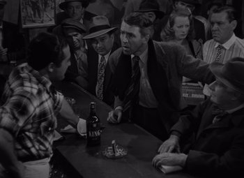 Movie still from “It's a Wonderful Life” (1946), directed by Frank Capra – A group of people sitting around a bar; Medium shot, High angle