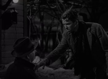 Movie still from “It's a Wonderful Life” (1946), directed by Frank Capra – Two men are shaking hands in a black and white photo; Medium shot, Over the shoulder angle