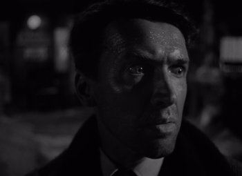 Movie still from “It's a Wonderful Life” (1946), directed by Frank Capra – Black and white photograph of a man in a suit; Close Up shot, Low angle