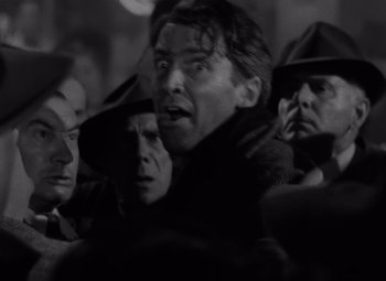 Movie still from “It's a Wonderful Life” (1946), directed by Frank Capra – Black and white photograph of a crowd of people; Close Up shot, Low angle