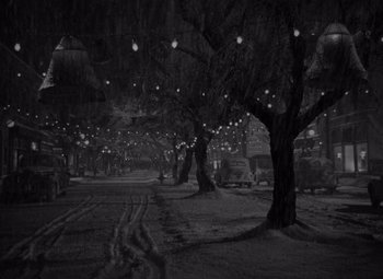 Movie still from “It's a Wonderful Life” (1946), directed by Frank Capra – A black - and - white photo of trees in the dark; Extreme Wide shot, High angle