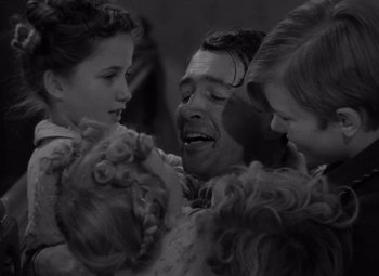 Movie still from “It's a Wonderful Life” (1946), directed by Frank Capra – A black and white photo of a man and two girls; Close Up shot, High angle