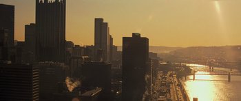 Movie still from “Jack Reacher” (2012), directed by Christopher McQuarrie – A view of a city skyline at sunset; Extreme Wide shot, High angle