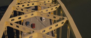 Movie still from “Jack Reacher” (2012), directed by Christopher McQuarrie – A view of a bridge from a car window looking down; Extreme Wide shot, Overhead angle