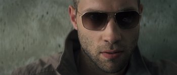 Movie still from “Jack Reacher” (2012), directed by Christopher McQuarrie – A person wearing sunglasses; Close Up shot, Low angle