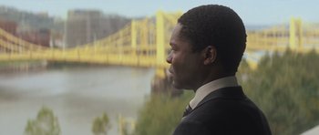 Movie still from “Jack Reacher” (2012), directed by Christopher McQuarrie – A man in a suit looking out of a window; Close Up shot, Over the shoulder angle