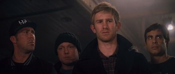 Movie still from “Jack Reacher” (2012), directed by Christopher McQuarrie – Two men standing next to each other in a dark room; Close Up shot, Low angle