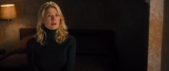 Movie still from “Jack Reacher” (2012), directed by Christopher McQuarrie – A woman in a black sweater sitting on a couch; Close Up shot, Over the shoulder angle