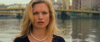 Movie still from “Jack Reacher” (2012), directed by Christopher McQuarrie – A woman wearing a pearl necklace standing in front of a body of water; Close Up shot, Over the shoulder angle