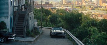 Movie still from “Jack Reacher” (2012), directed by Christopher McQuarrie – A car parked on the side of a road; Extreme Wide shot, High angle