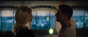 Movie still from “Jack Reacher” (2012), directed by Christopher McQuarrie – A man and a woman face to face in front of a window; Medium shot, Low angle