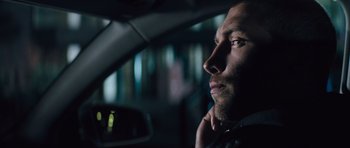 Movie still from “Jack Reacher” (2012), directed by Christopher McQuarrie – A person sitting in a car; Close Up shot, Low angle