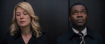 Movie still from “Jack Reacher” (2012), directed by Christopher McQuarrie – A man and a woman standing next to each other; Close Up shot, Low angle