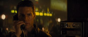 Movie still from “Jack Reacher” (2012), directed by Christopher McQuarrie – A man is looking into the distance while holding a cell phone; Close Up shot, Over the shoulder angle