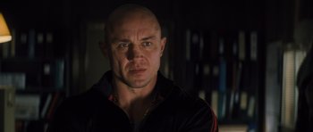 Movie still from “Jack Reacher” (2012), directed by Christopher McQuarrie – A man with bald head wearing a black jacket; Close Up shot, Low angle