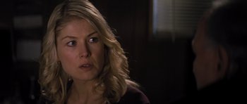 Movie still from “Jack Reacher” (2012), directed by Christopher McQuarrie – A person with long blonde hair; Close Up shot, Over the shoulder angle