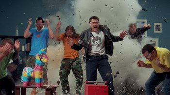 Movie still from “Jackass 4.5” (2022), directed by Jeff Tremaine – A group of people standing next to each other in front of smoke; Wide shot, Low angle
