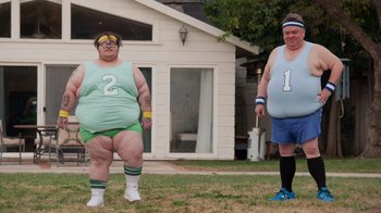 Movie still from “Jackass 4.5” (2022), directed by Jeff Tremaine – A couple of people that are standing in the grass; Wide shot, Low angle