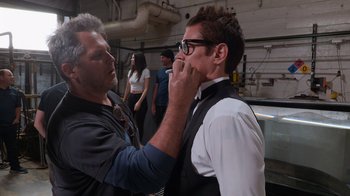 Movie still from “Jackass 4.5” (2022), directed by Jeff Tremaine – A man is putting on a pair of eyeglasses on another man's face; Medium shot, Over the shoulder angle