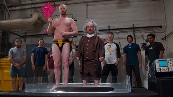 Movie still from “Jackass 4.5” (2022), directed by Jeff Tremaine – A man in underwear standing next to a man in a suit; Wide shot, Low angle