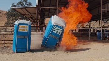 Movie still from “Jackass 4.5” (2022), directed by Jeff Tremaine – An open toilet sitting on top of a dirt field; Extreme Wide shot, High angle