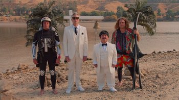 Movie still from “Jackass 4.5” (2022), directed by Jeff Tremaine – A group of people dressed up in white suits; Wide shot, Low angle