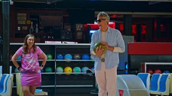 Movie still from “Jackass 4.5” (2022), directed by Jeff Tremaine – A man standing in a bowling alley holding a watermelon; Medium shot, Low angle