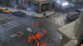 Movie still from “Jackass 4.5” (2022), directed by Jeff Tremaine – A street light on fire on the side of the road; Extreme Wide shot, High angle
