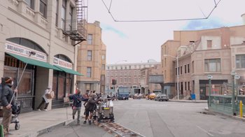 Movie still from “Jackass 4.5” (2022), directed by Jeff Tremaine – A group of people standing on the side of the street; Extreme Wide shot, High angle