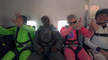 Movie still from “Jackass 4.5” (2022), directed by Jeff Tremaine – A group of parachutists sitting on top of an airplane; Medium shot, Low angle