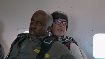 Movie still from “Jackass 4.5” (2022), directed by Jeff Tremaine – Two men in full flight suits and a helmet; Close Up shot, Low angle